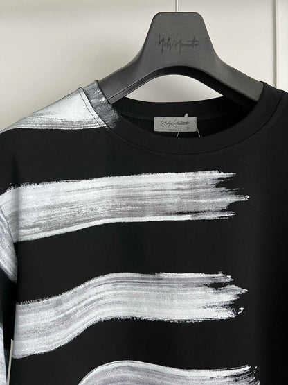 Black and white striped shirt on a hanger with a visible brand label.