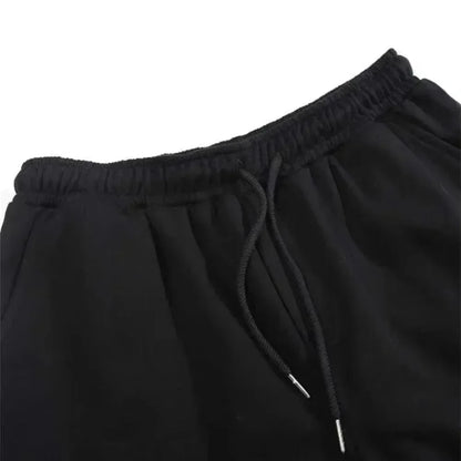 Close-up of black drawstring pants on a white background