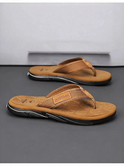 Pair of brown sandals on a gray surface with a neutral background