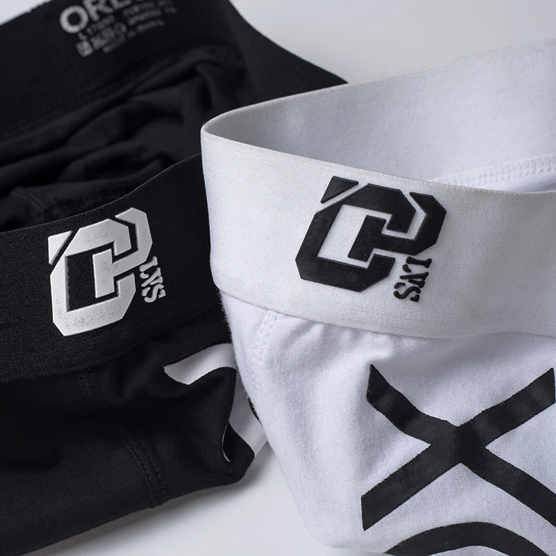 Black and white athletic shorts with a logo on a white background
