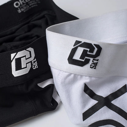 Black and white athletic shorts with a logo on a white background