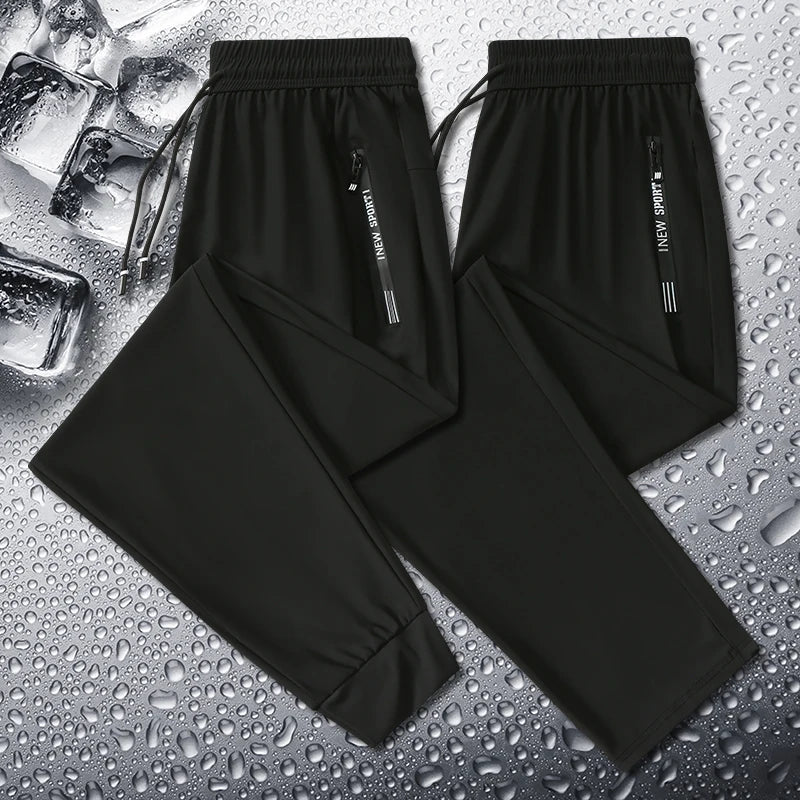 Black pants with a brand label on a wet surface