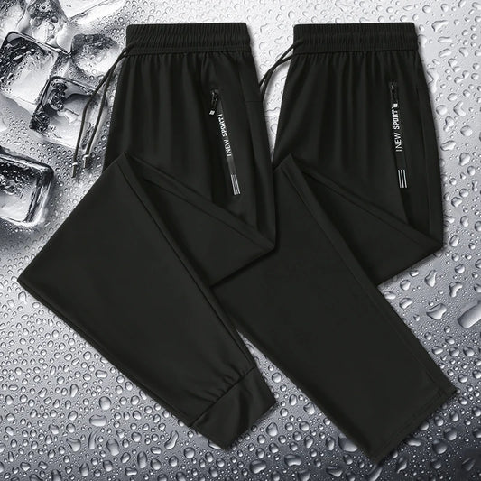 Black pants with a brand label on a wet surface