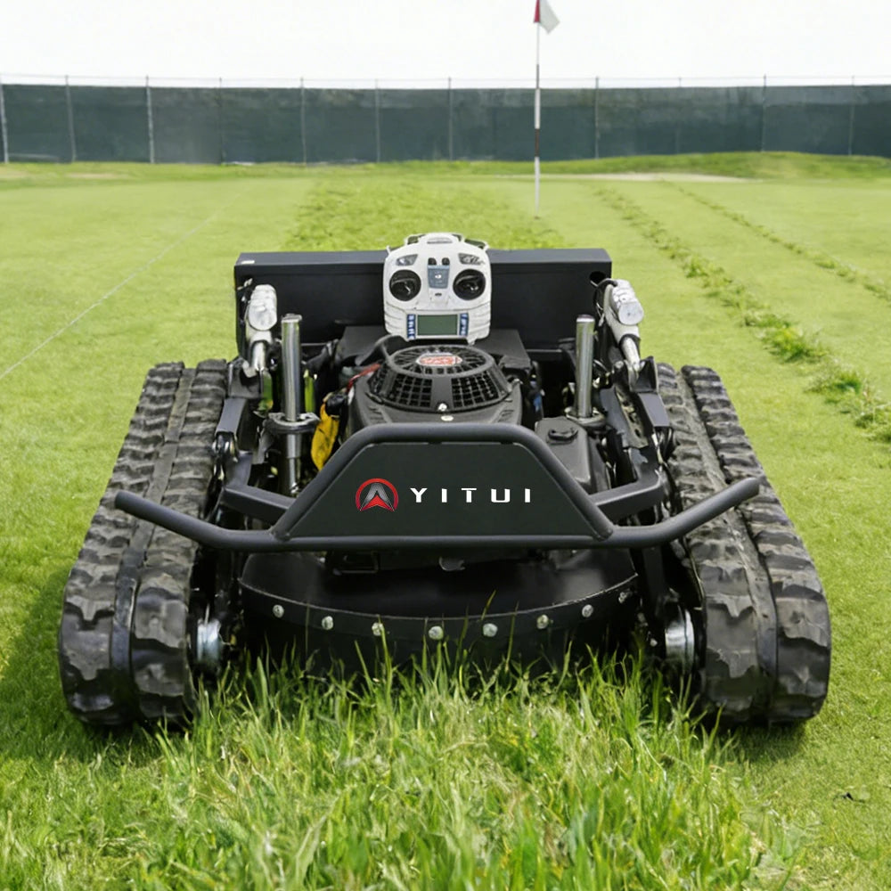 Robotic lawn mower on a grassy field with 'YITUI' branding.