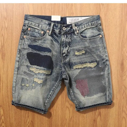 Distressed denim shorts on a wooden surface