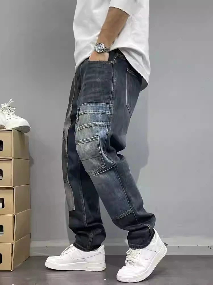 Person wearing dark jeans and white sneakers on a gray background