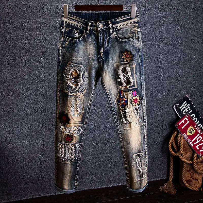 Decorative jeans with embellishments on a gray background