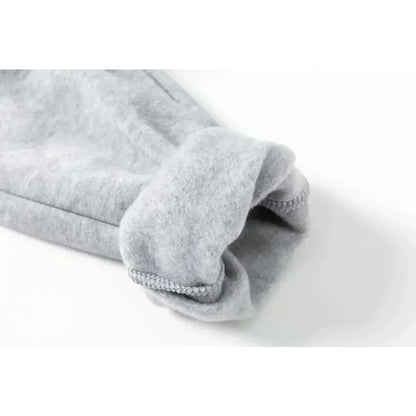 Folded gray fleece blanket on a white background