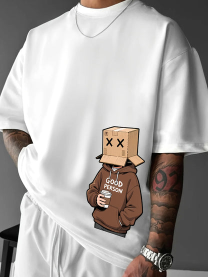 Person wearing a white oversized t-shirt with a graphic of a person in a brown hoodie and box head, holding a coffee cup, labeled 'Good Person'.