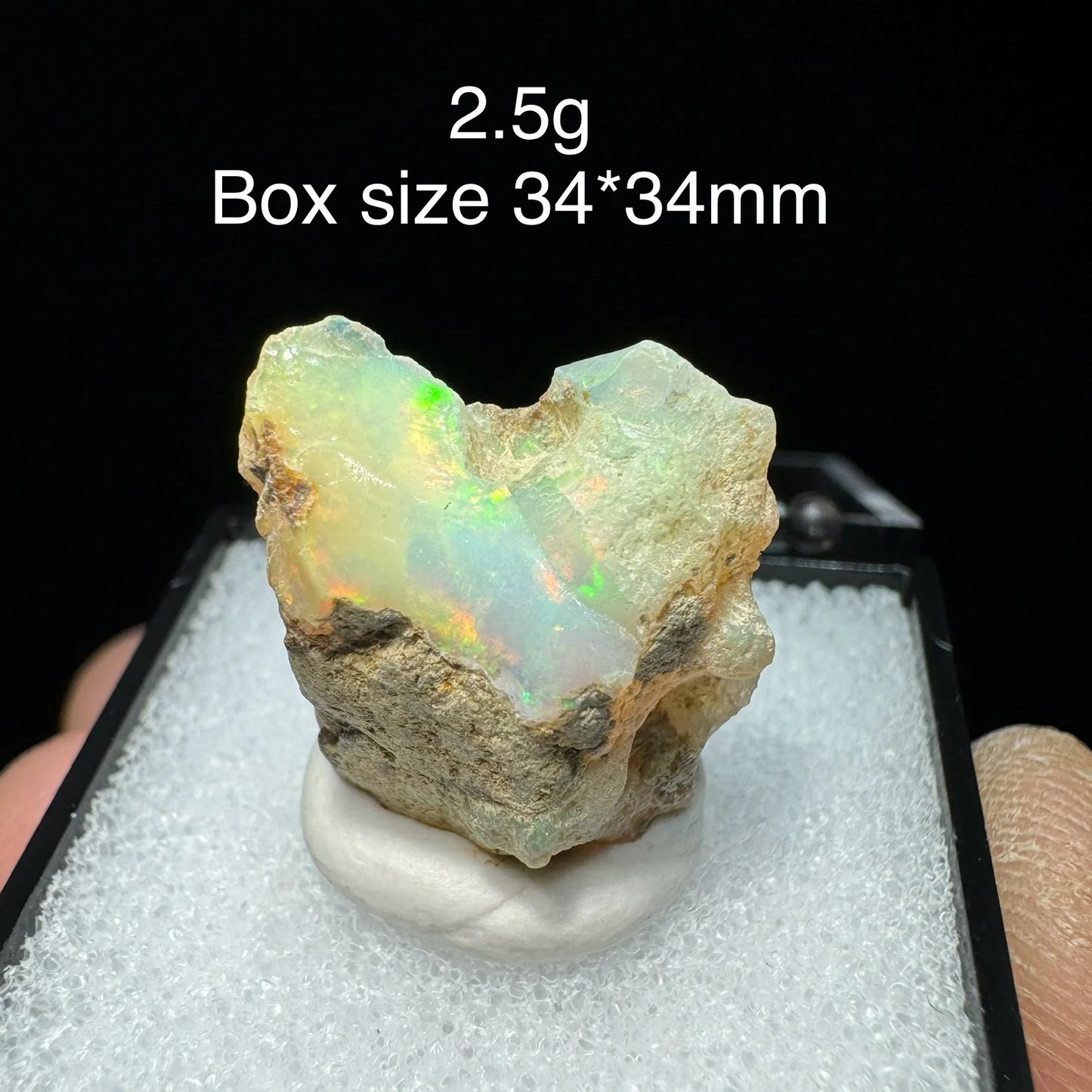 Opal stone with size and weight information on a black background