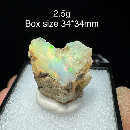 Opal stone with size and weight information on a black background