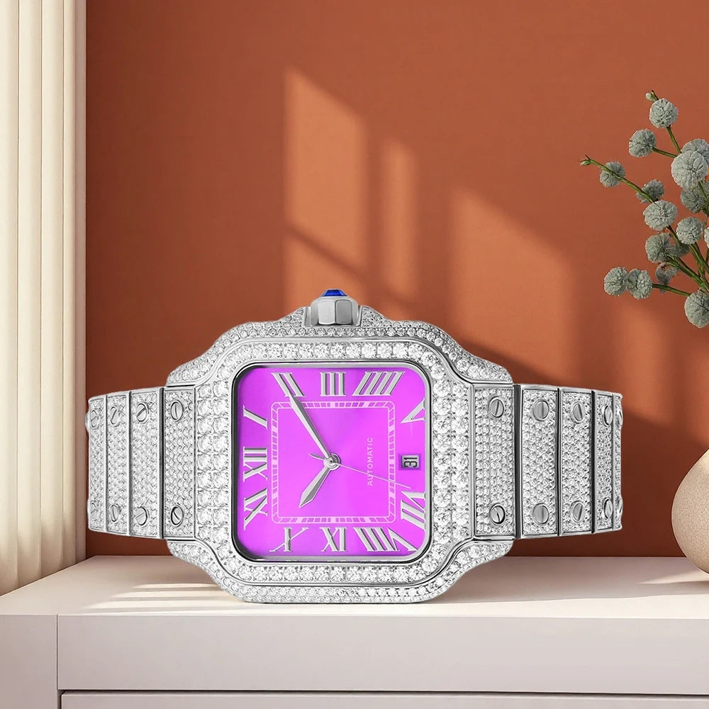 Luxury watch with a pink face and diamond-studded case on a wooden surface.