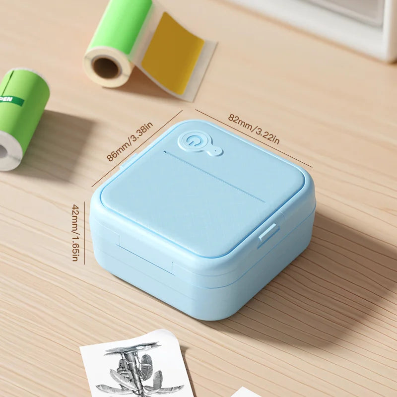 Blue portable printer on a wooden surface with measurements displayed