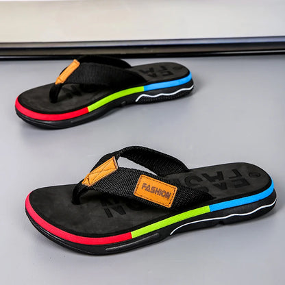 Black flip-flops with colorful stripes on a gray surface