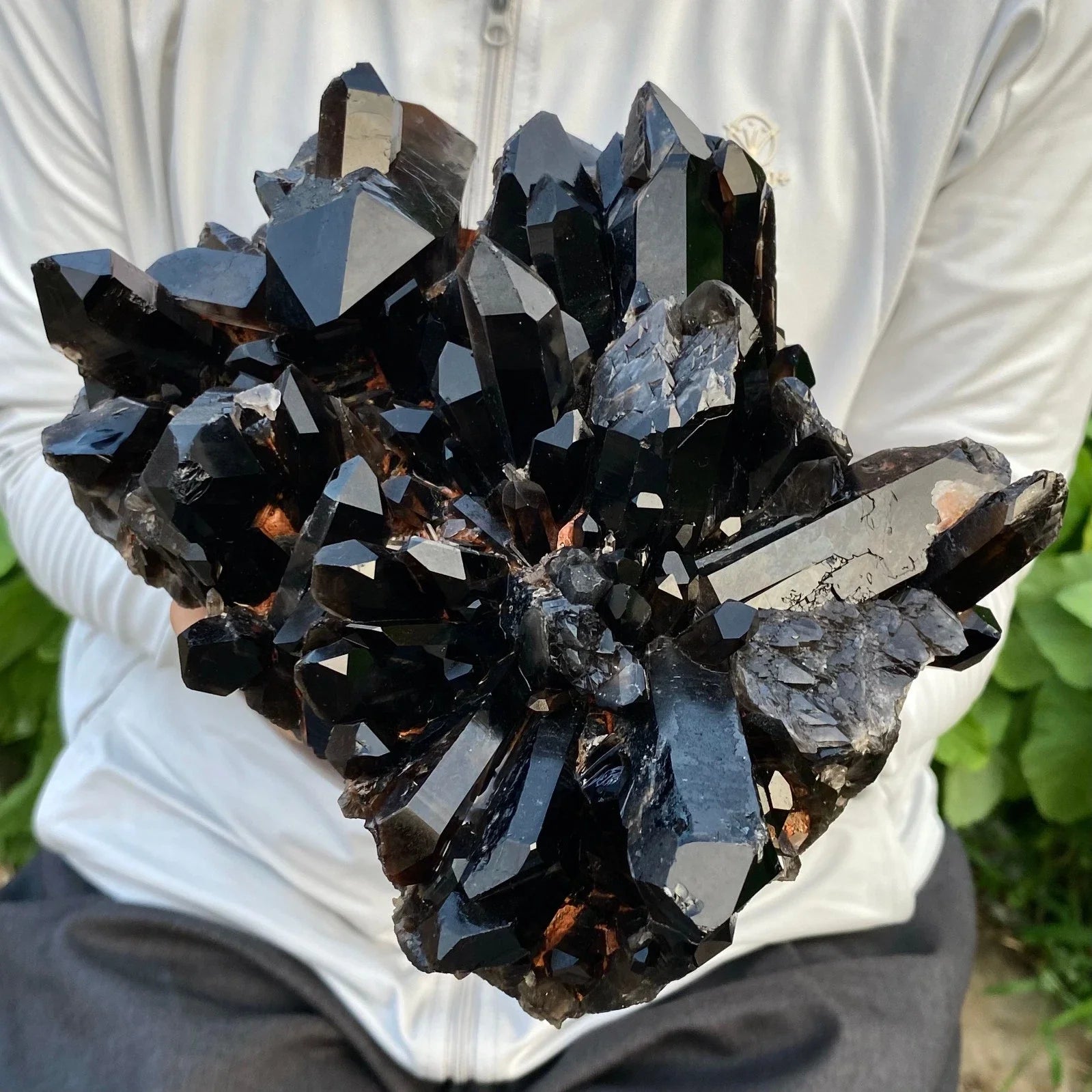 Mineral specimen held by a person with a blurred background