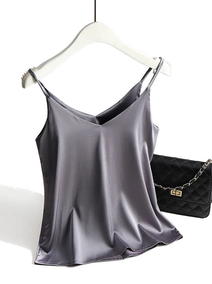 Gray satin camisole on a hanger with a black handbag in the background