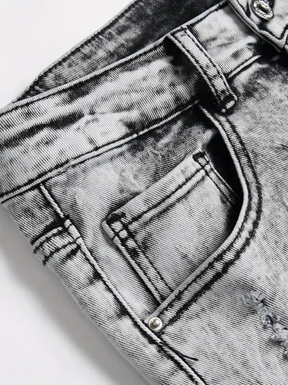 Close-up of a gray acid-wash denim pocket with stitching details.