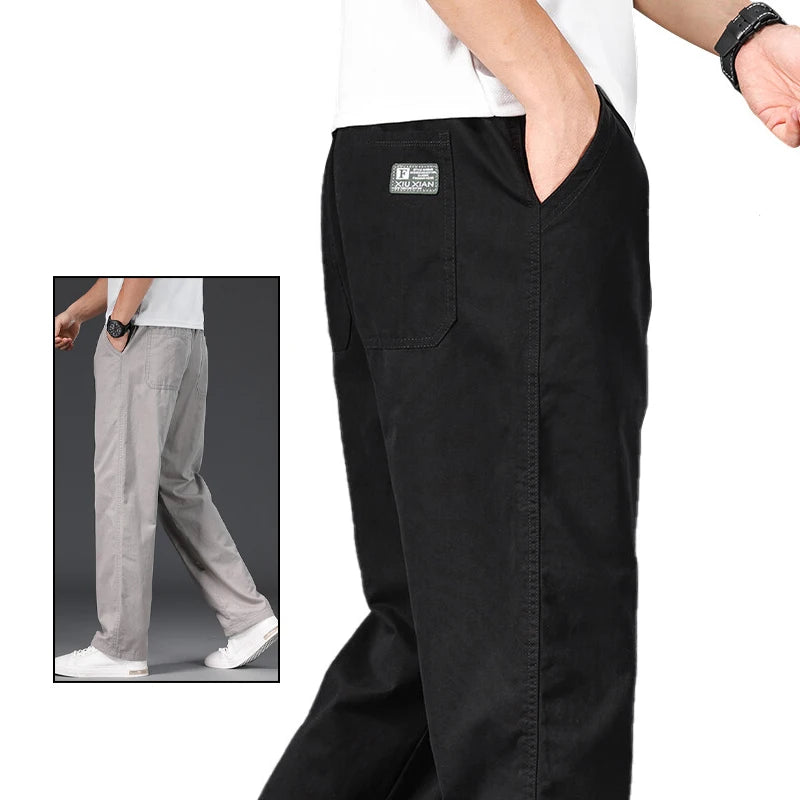 Black pants with a small logo on the pocket, worn by a person, with an inset showing gray pants.
