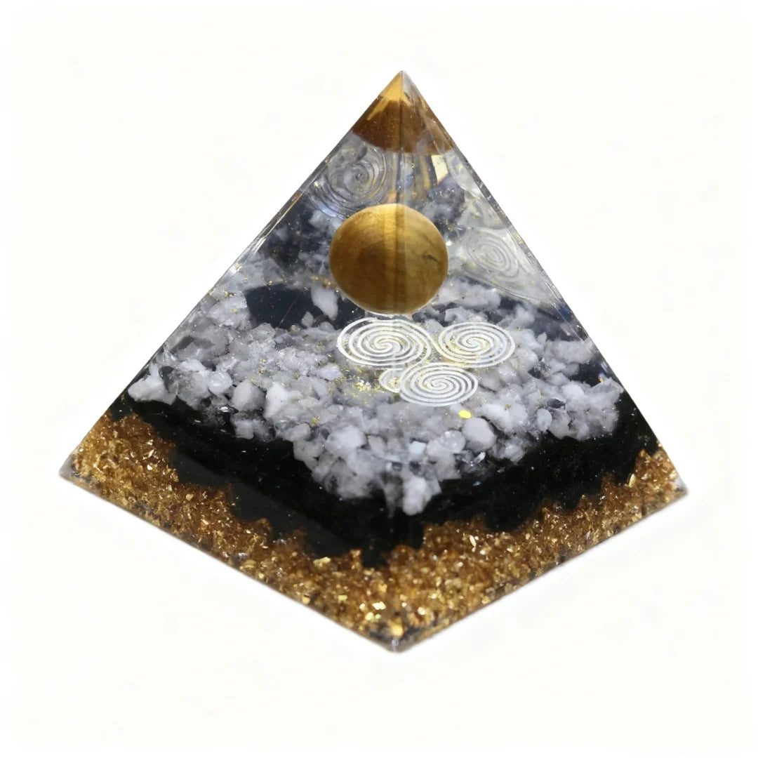 Pyramid-shaped object with gold and black design on a white background