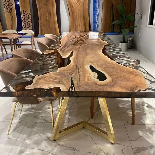 Wooden dining table with gold legs in a modern interior setting