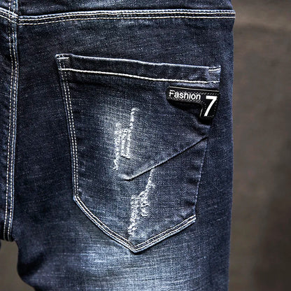 Close-up of a blue denim pocket with a 'Fashion 7' label on a blurred background