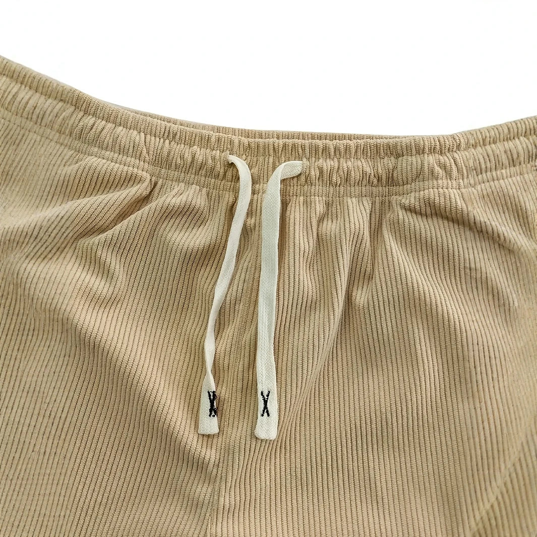 Beige corduroy pants with drawstring on a white background
