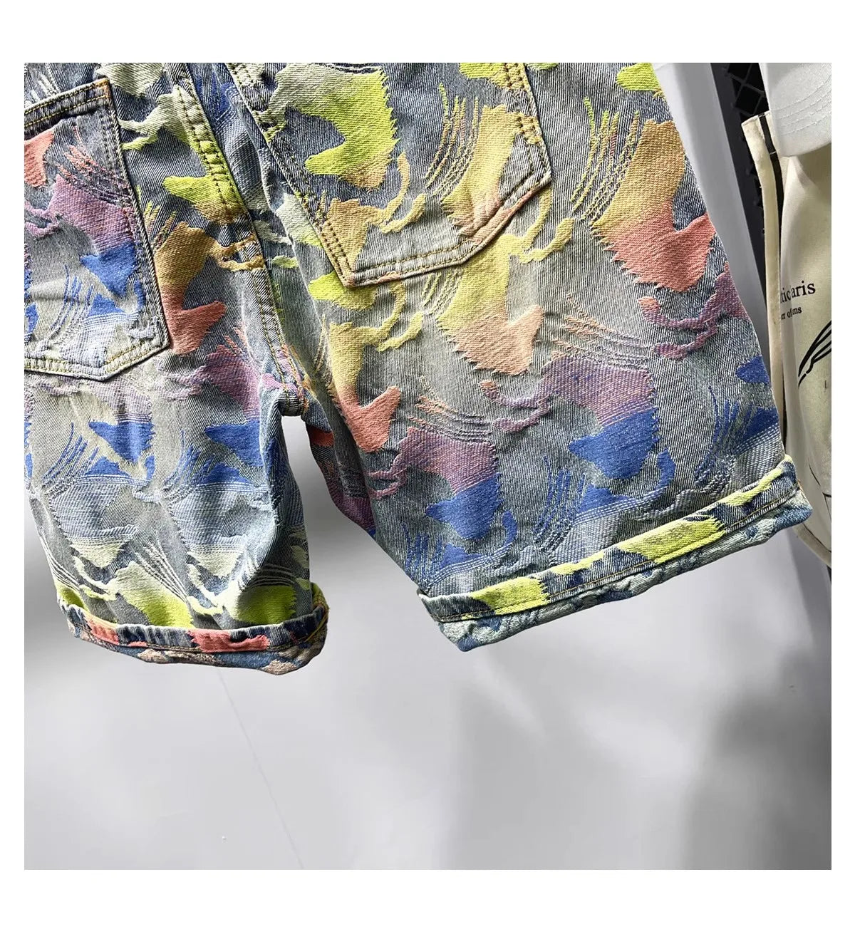 Colorful floral-patterned denim jacket on a white background