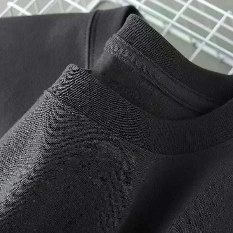 Close-up of black sweatpants with a white background