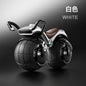 Children's toy motorcycle with large wheels on a dark background
