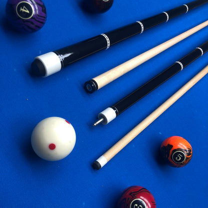 Pool cues and balls on a blue felt surface
