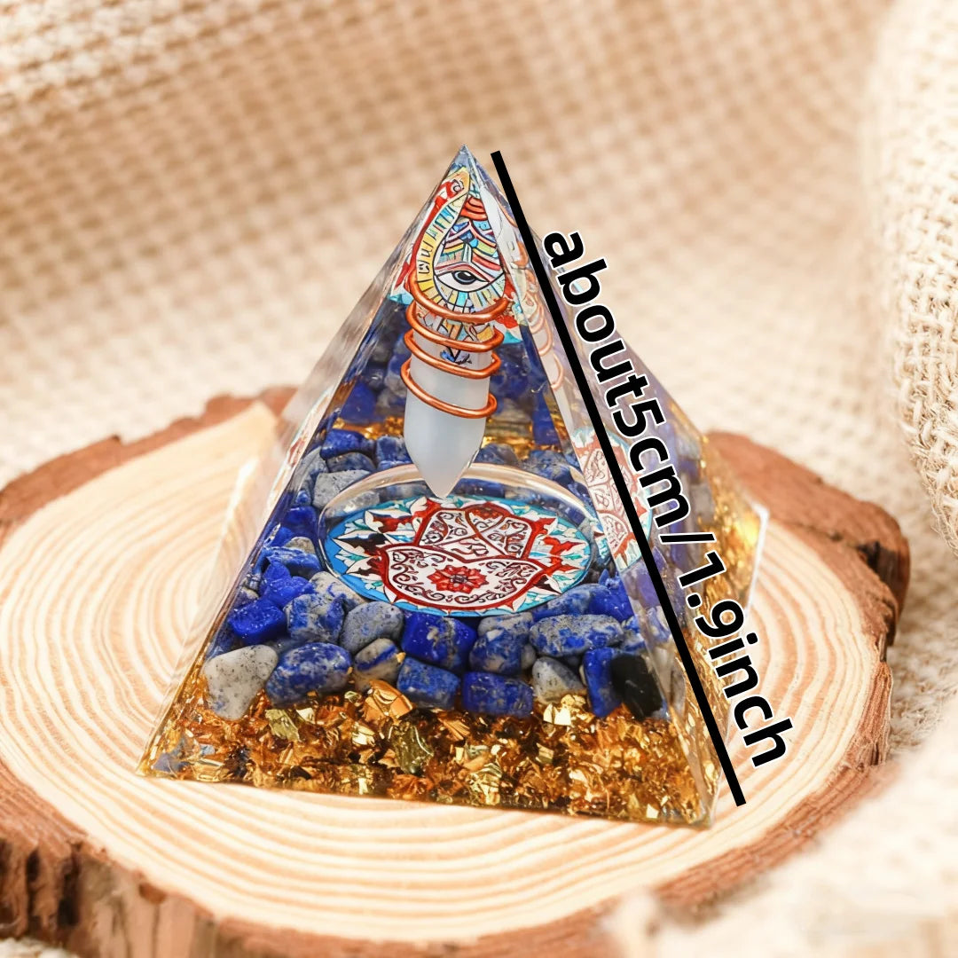 Pyramid-shaped crystal with colorful design on a wooden base