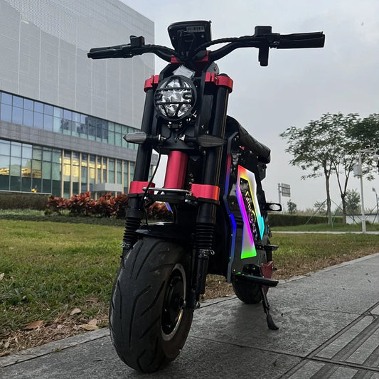 Black electric scooter with colorful design on a sidewalk near a modern building.