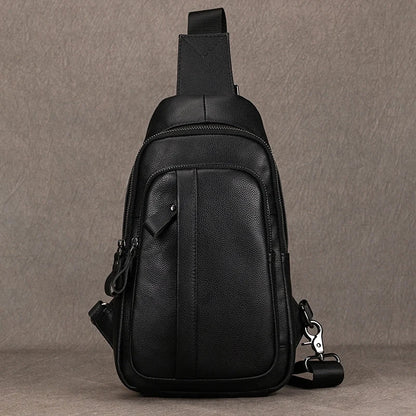 Black leather sling bag on a gray background