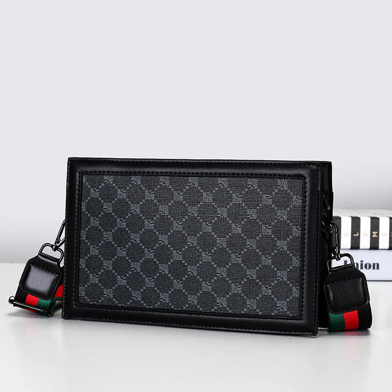 Black patterned handbag with colorful strap on a white background