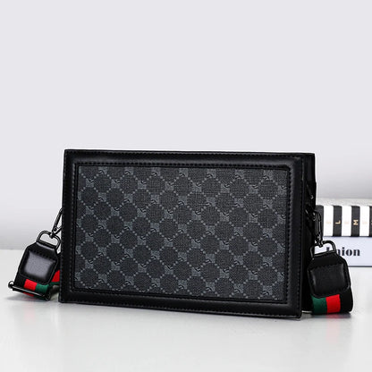 Black patterned handbag with colorful strap on a white background