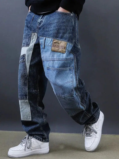 Person wearing patchwork jeans with a visible brand label against a gray background