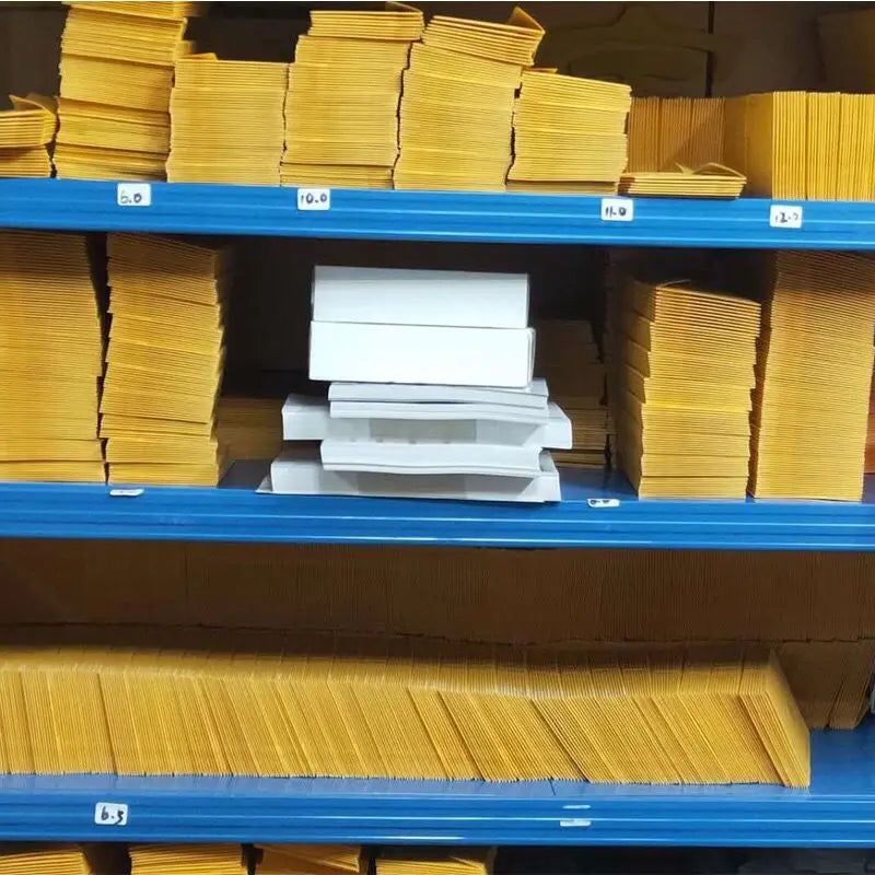Shelves with stacks of yellow and white boxes in a storage area.