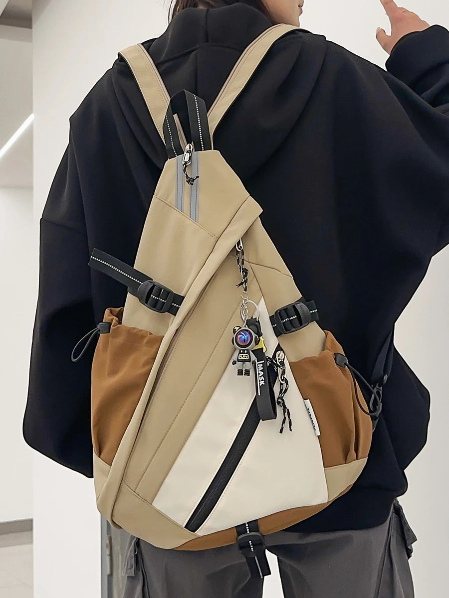 Person wearing a beige and brown backpack with a black jacket.