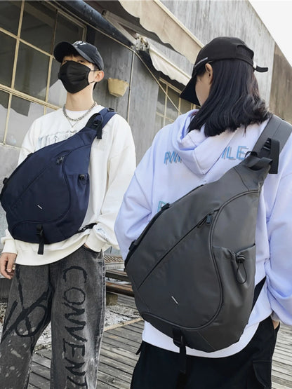 Two people wearing backpacks in an urban setting