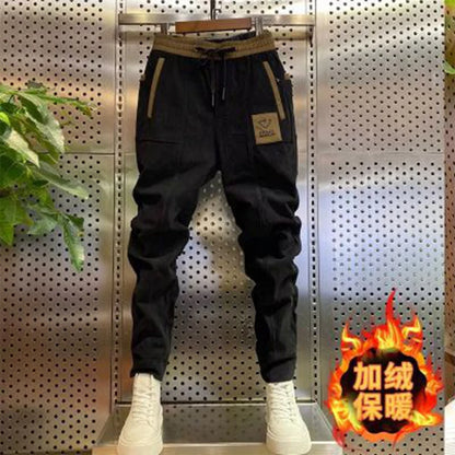 Black pants with white sneakers on a metallic background