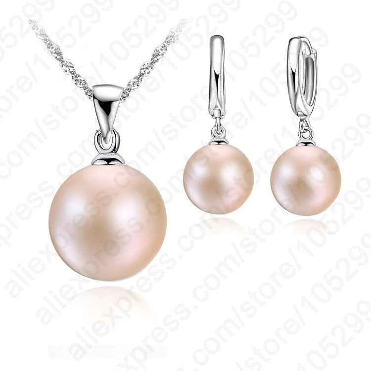 Pearl necklace and earrings set on a white background