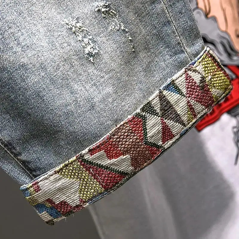 Close-up of a colorful woven belt on a denim background