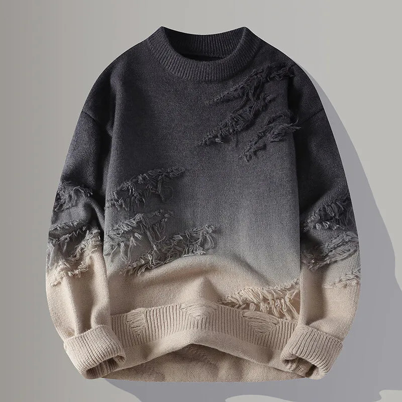 Gray and beige distressed sweater on a gray background