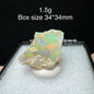 Opal stone on a white stand with text indicating weight and box size.
