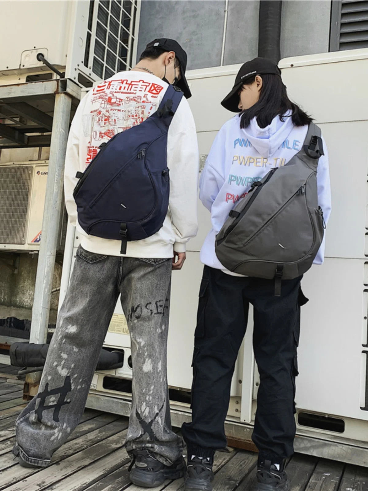 Two people wearing backpacks standing outdoors near a building.