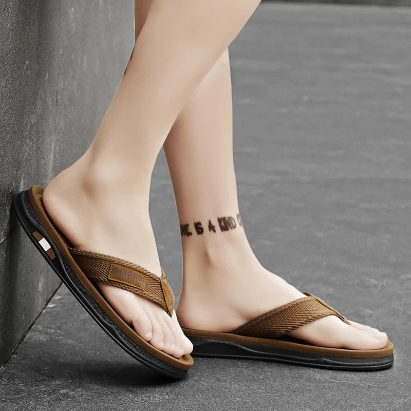Brown sandals worn by a person on a gray pavement.