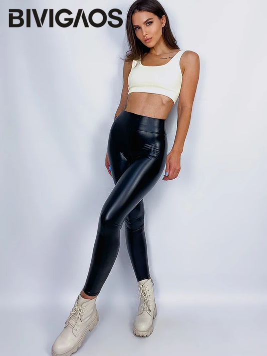 Woman wearing a white crop top and black shiny leggings with 'BIVIGAOS' branding.