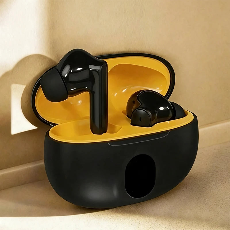 Black wireless earbuds in a yellow charging case on a beige surface