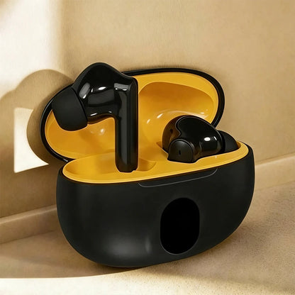 Black wireless earbuds in a yellow charging case on a beige surface