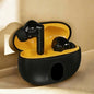 Black wireless earbuds in a yellow charging case on a beige surface